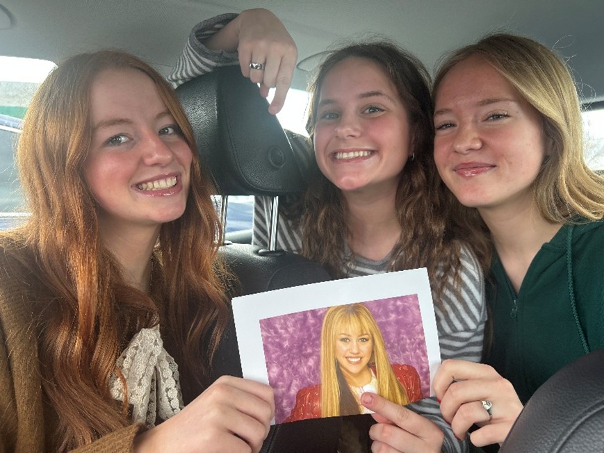 Seniors Audrey Baxter, Mary Richardson and Kylie Talbot await the twentieth anniversary of Hannah Montana by blasting her songs and looking at her franchise posters.