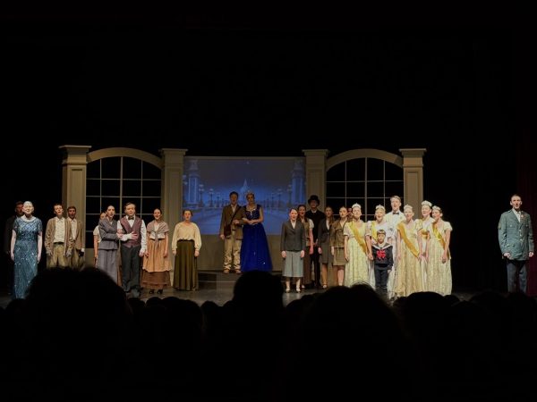The Eagle High drama department’s cast of “Anastasia” stand on stage and perform their closing number. Junior Tanner Morey and senior Allyson Godfrey stand center stage and address the crowd at the final curtain call while surrounded by fellow cast members.