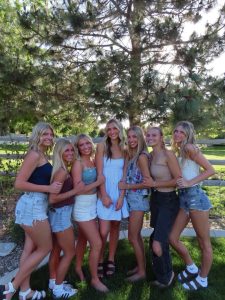 Senior Addie Wall, junior Isla Anderson, senior Brooklyn Broadbent, graduate Malia Anderson and senior Brielle Dahlgren attend graduate Alauna Watt’s graduation party in 2025. There was swimming, volleyball, cornhole and eating, which lots a people will be incorporating in their 2026 graduation parties.